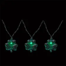Three glowing shamrock lights in a row